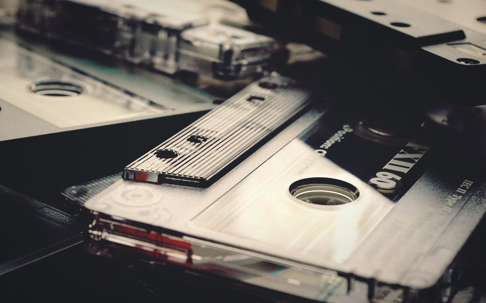 Close-up of stacked cassette tapes with visible reels and labels
